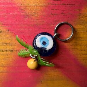 Glass Evil Eye Keychain with Yellow Bell and Green Leaf Accents